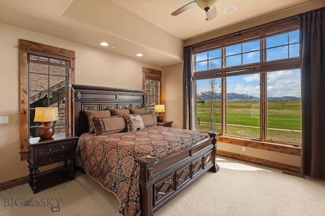 carpeted bedroom with baseboards, recessed lighting, and multiple windows