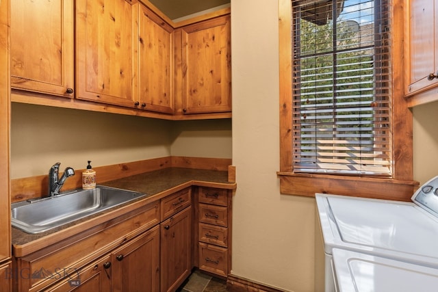 laundry room featuring a sink, cabinet space, and washer and dryer