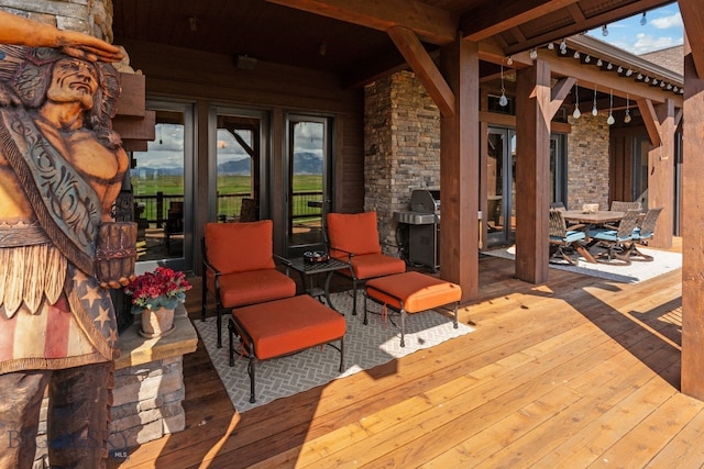deck with grilling area and outdoor dining area