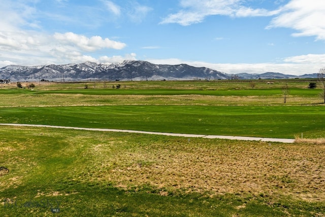 view of property's community featuring a yard and a mountain view