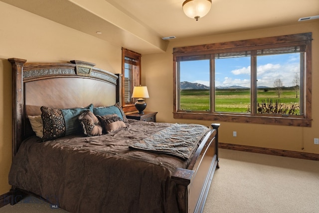 carpeted bedroom with baseboards and visible vents