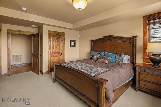 carpeted bedroom with visible vents