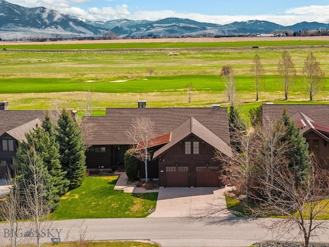 drone / aerial view with a mountain view and a rural view