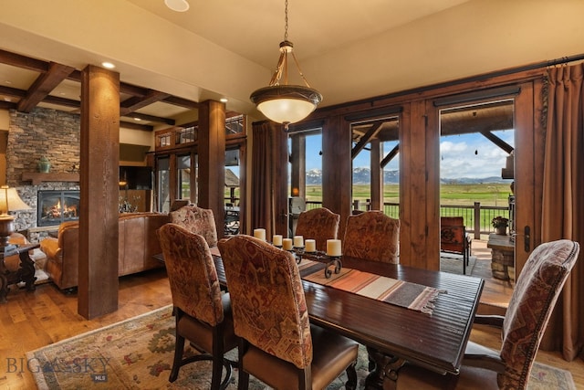 dining room featuring recessed lighting, beam ceiling, wood finished floors, and a fireplace