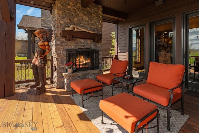 view of patio / terrace featuring an outdoor stone fireplace and a deck
