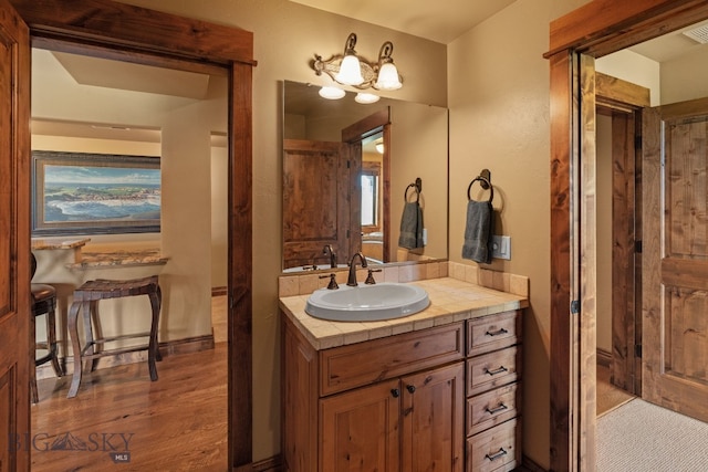 bathroom with vanity, wood finished floors, and visible vents
