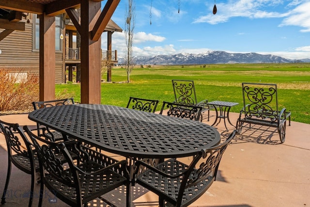 view of patio with a mountain view and outdoor dining space