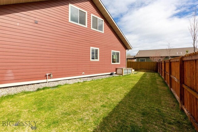 921 New Mexico Dr, Belgrade, MT 59714 - view of property exterior featuring a fenced backyard and a lawn