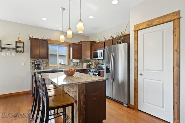 921 New Mexico Dr, Belgrade, MT 59714 - kitchen featuring light wood-type flooring, appliances with stainless steel finishes, and backsplash