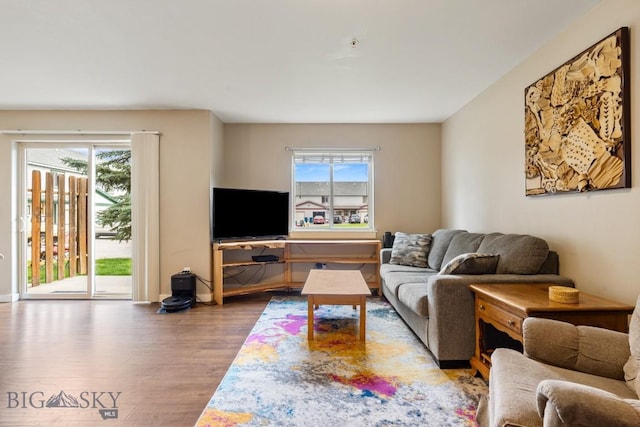 living room with baseboards, plenty of natural light, and wood finished floors