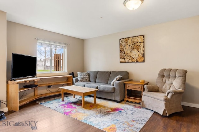 living area featuring baseboards and wood finished floors