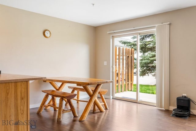 dining area with baseboards and dark wood-style floors