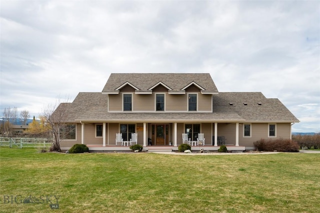 country-style home with a front lawn, roof with shingles, fence, and covered porch