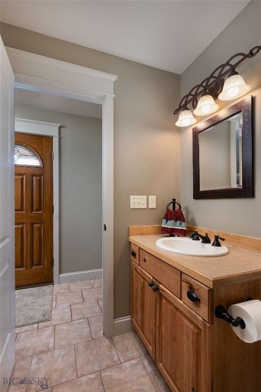 bathroom with vanity and baseboards