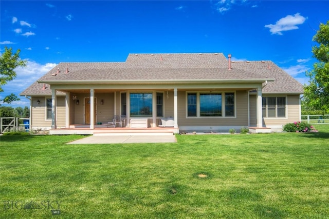 back of property featuring fence and a yard
