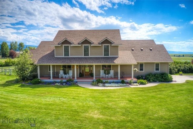 view of front of home featuring a porch, a shingled roof, and a front lawn