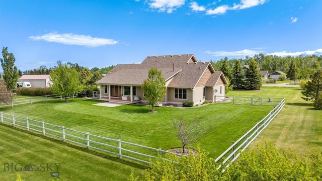 rear view of property with a patio, a fenced backyard, and a yard