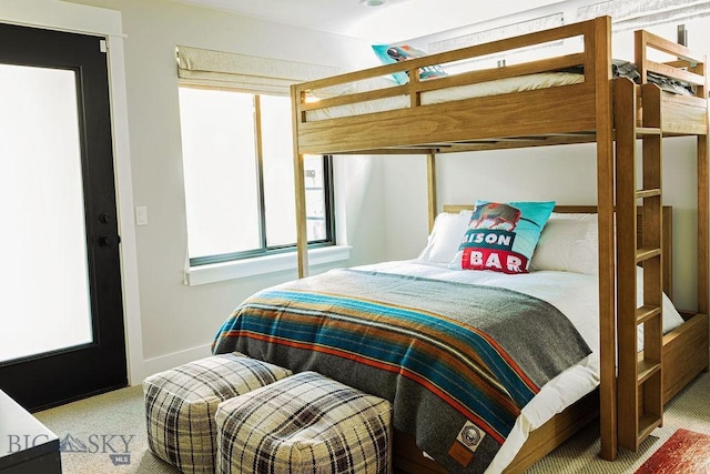 carpeted bedroom featuring baseboards