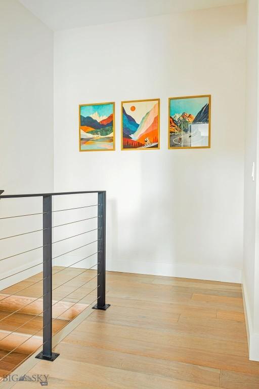 interior space with baseboards and wood finished floors