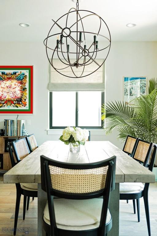 dining area with recessed lighting, an inviting chandelier, and wood finished floors