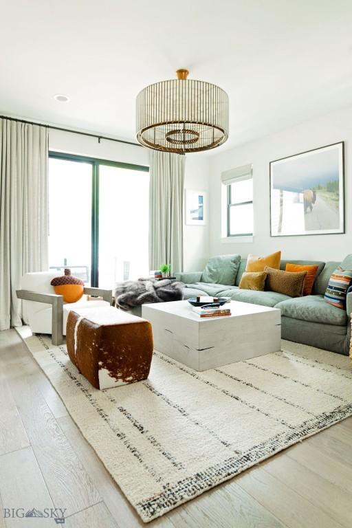 living room with an inviting chandelier and wood finished floors