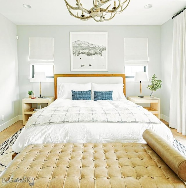 bedroom with baseboards, recessed lighting, and a chandelier