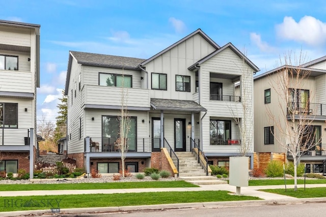 townhome / multi-family property featuring board and batten siding, stairway, and a balcony