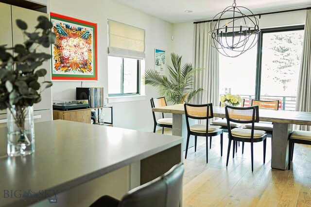 dining room with a notable chandelier and light wood-style floors