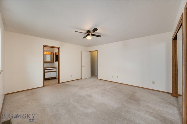 unfurnished bedroom with baseboards, ceiling fan, ensuite bath, and light colored carpet