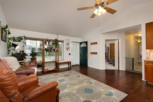 living area with baseboards, dark wood finished floors, ceiling fan, and high vaulted ceiling
