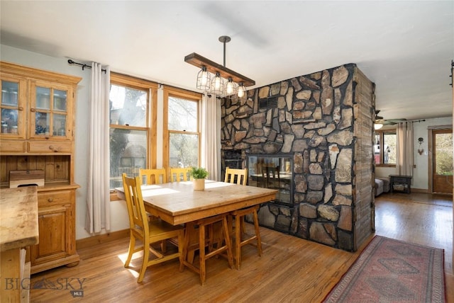 209 N 5th St, Manhattan, MT 59741 - dining space with light wood-type flooring and a stone fireplace