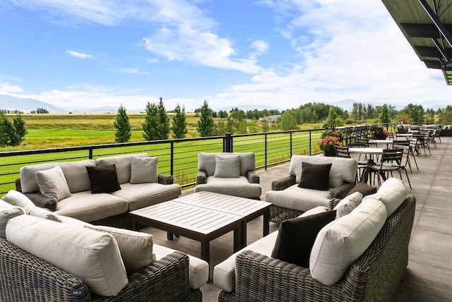 view of patio featuring outdoor lounge area, a mountain view, and a rural view