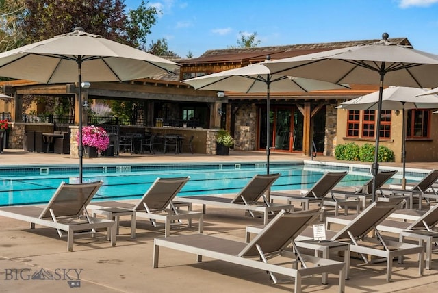 community pool featuring fence and a patio area
