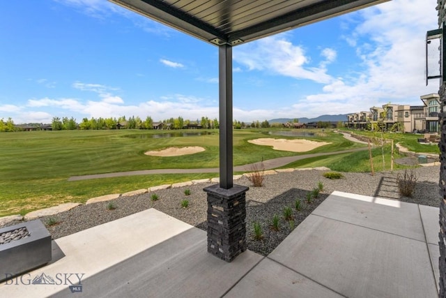 view of home's community with view of golf course, a yard, and a patio