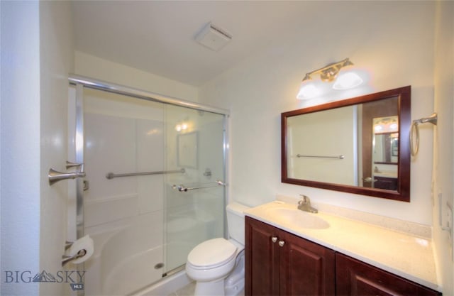 bathroom featuring vanity, toilet, and a stall shower