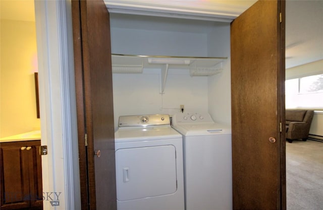 laundry room featuring washer and dryer, laundry area, and light colored carpet