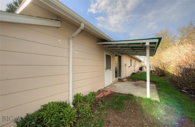 view of side of home with a patio area