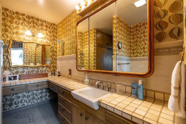 423 Riverview Ct, Great Falls, MT 59404 - bathroom with vanity, decorative backsplash, wallpapered walls, and tile walls