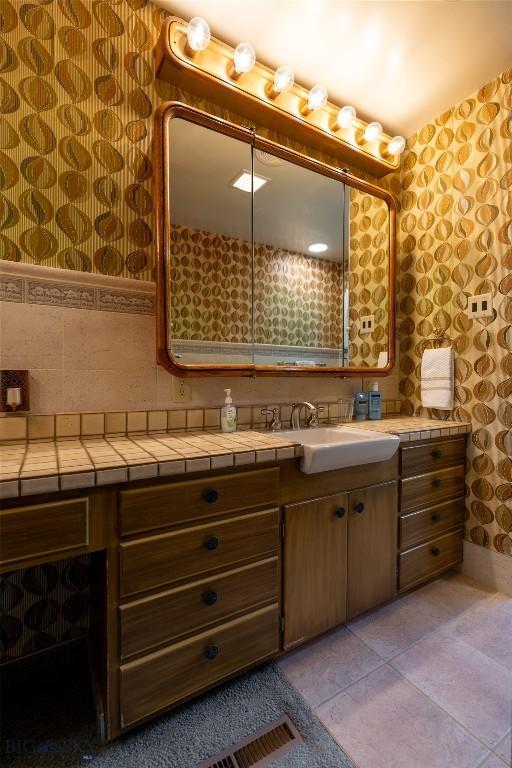 423 Riverview Ct, Great Falls, MT 59404 - bathroom with vanity, tile patterned flooring, and wallpapered walls