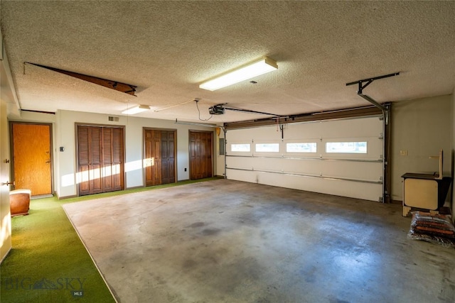 423 Riverview Ct, Great Falls, MT 59404 - garage featuring a garage door opener and visible vents