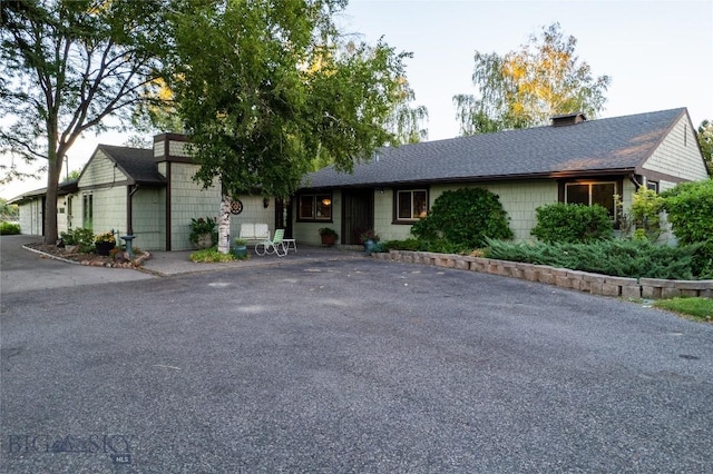 423 Riverview Ct, Great Falls, MT 59404 - ranch-style house featuring a shingled roof, a chimney, and driveway