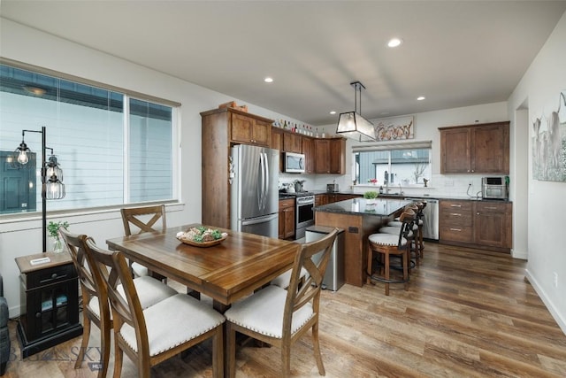 dining room with recessed lighting and wood finished floors