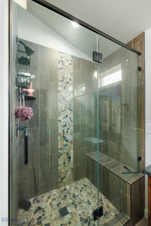 131 Stallion, Bozeman, MT 59718 - full bathroom featuring vaulted ceiling and a shower stall