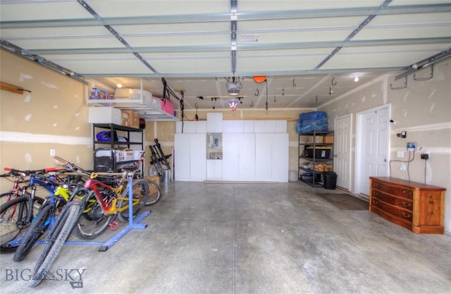 garage featuring a garage door opener and electric panel