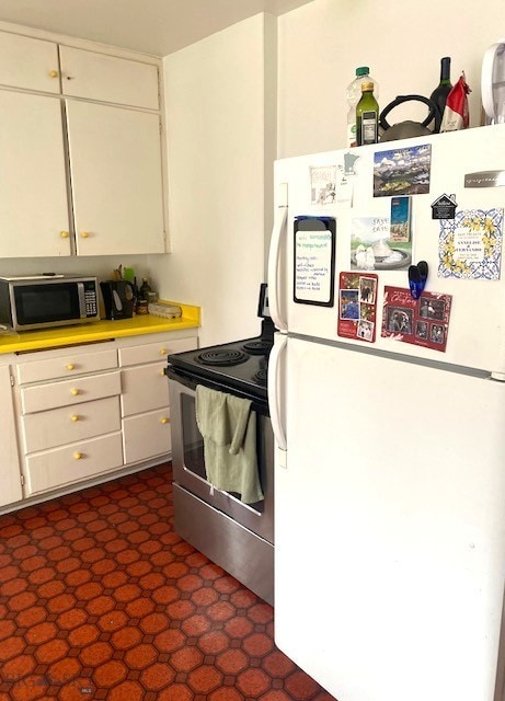 kitchen featuring light countertops, white cabinetry, and appliances with stainless steel finishes