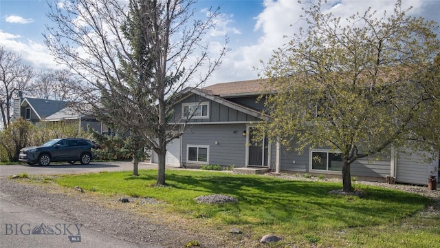 417 Henry Dr, Belgrade, MT 59714 - view of front of house featuring board and batten siding, an attached garage, driveway, and a front yard