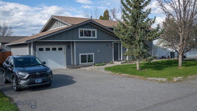417 Henry Dr, Belgrade, MT 59714 - view of front of home with board and batten siding, a garage, asphalt driveway, a front yard, and a shingled roof