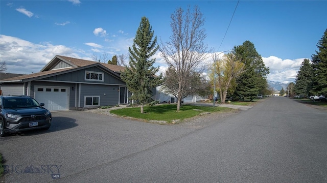 417 Henry Dr, Belgrade, MT 59714 - view of front of home with board and batten siding, an attached garage, driveway, and a front yard