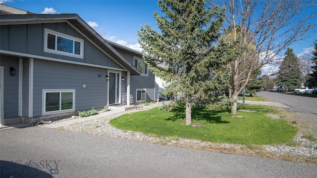 417 Henry Dr, Belgrade, MT 59714 - view of side of home with board and batten siding and a lawn