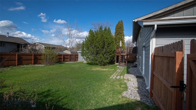 417 Henry Dr, Belgrade, MT 59714 - fenced backyard featuring stairway and a deck